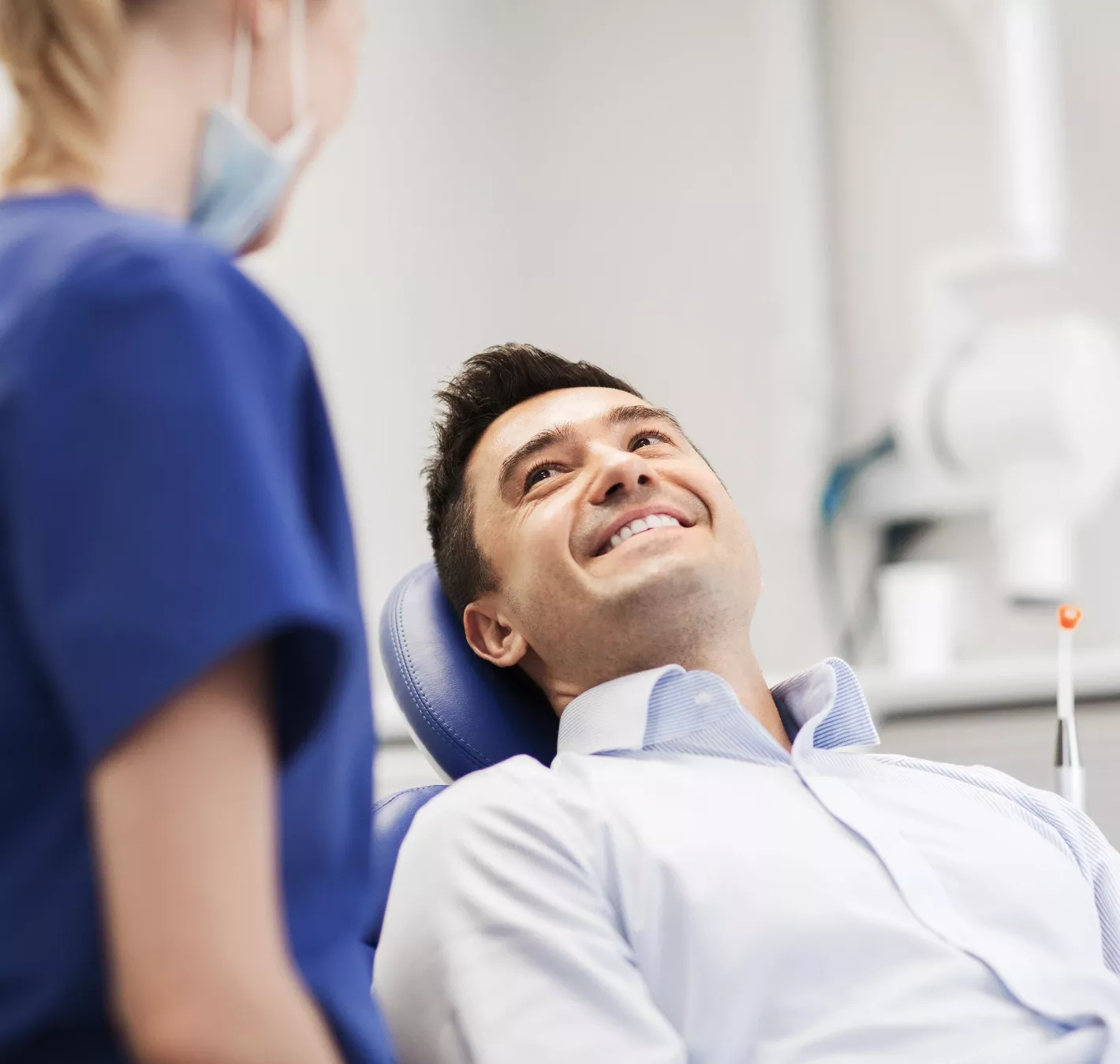 patient in chair smiling during exam
